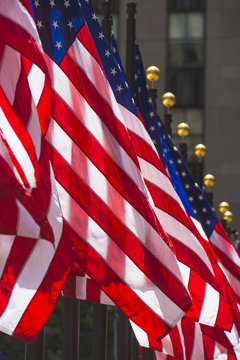 Row of American flags, close-up, New York, USA