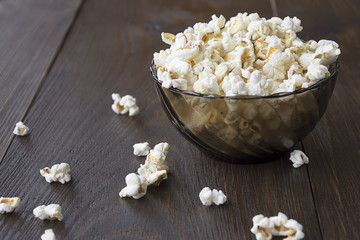 Salty popcorn on the wooden table