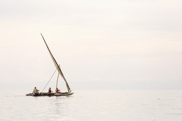 Fototapeta premium Traditional fisherman boat in Zanzibar on ocean with rainy cloud