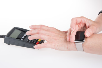 Hands of man using her smart watch to pay