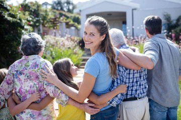Naklejka premium Multi-generation family walking on the garden path