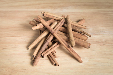 pile of cinnamon stick on a wood background