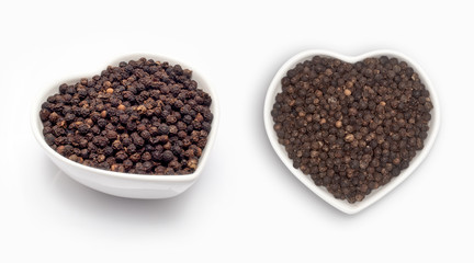 black pepper  in a heart shaped bowl, isolated on white