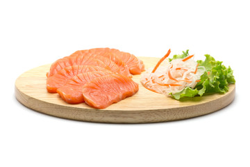 Sliced salmon on wood background
