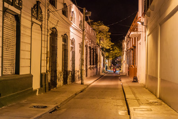 Fototapeta na wymiar View of a night street in the center of Santa Marta, Colombia