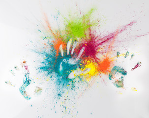 Hand imprints on colorful Holi powder. Happy Holi concept.