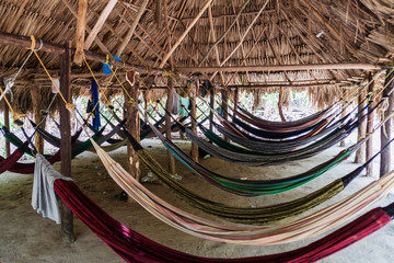 Hammocks hang in a hut in Tayrona National Park, Colombia