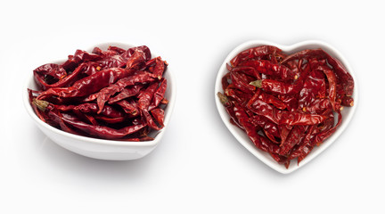 dried  chili  in a heart shaped bowl, isolated on white