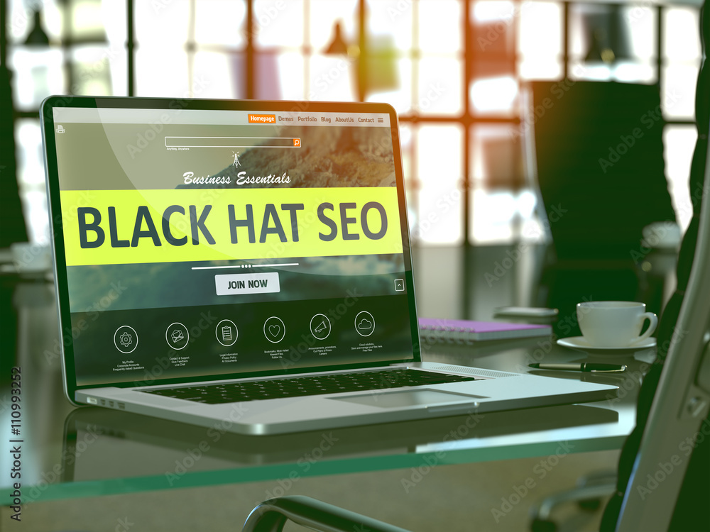 Poster modern workplace with laptop showing landing page with black hat seo concept. toned image with selec