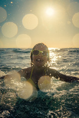Happy child playing in the sea