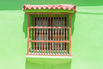 Naklejka premium View of the window of one of the colorful houses in center of Cartagena, Colombia.