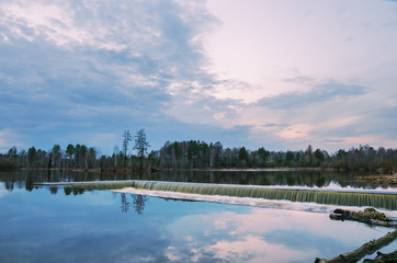 spring evening landscape with an unusual lake