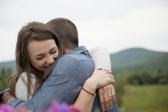 Couple embracing, outdoors