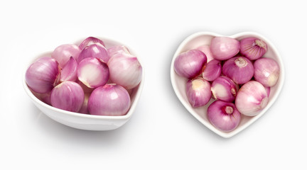 Shallot in a heart shaped bowl, isolated on white