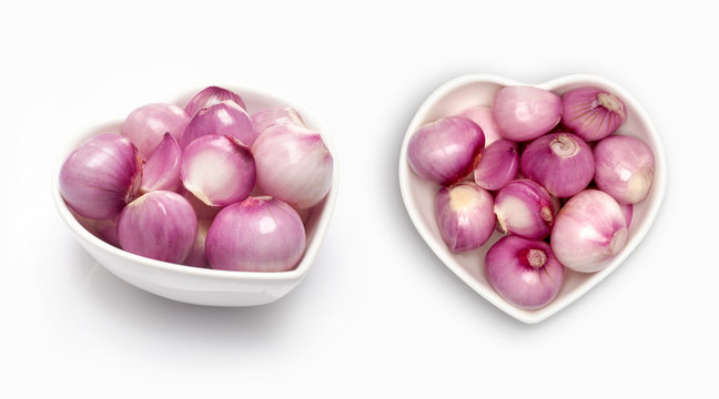 Shallot in a heart shaped bowl, isolated on white