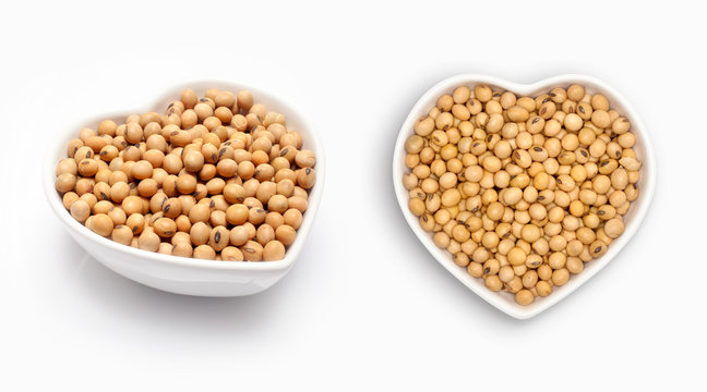 Soybean in a heart shaped bowl, isolated on white