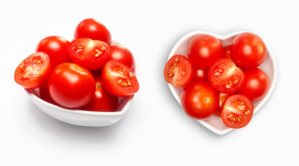 Cherry tomato  in a heart shaped bowl, isolated on white