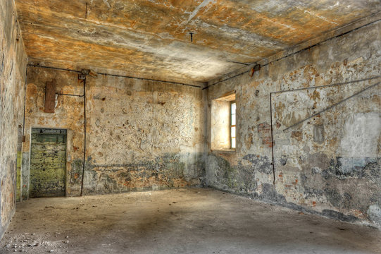 Empty, derelict room in an abandoned prison.