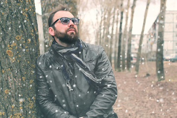 Fototapeta premium winter beard man in park with headphone