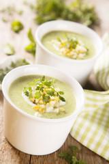 Zucchini soup with peas, decorated with egg