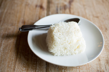White rice jamince on the wood table.