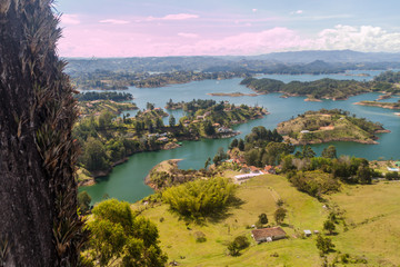 Fototapeta premium Steep Piedra del Penol rock, Colombia. Guatape dam lake in the background.