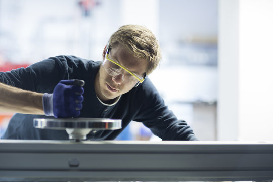Factory engineer testing machinery in factory