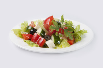 Greek Salad on white plate and gray background