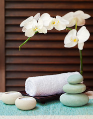 Spa and wellness massage setting Still life with candle, towel and stones