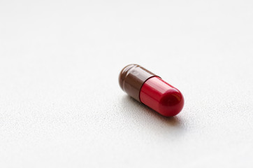 Medicine capsule / Red-brown capsules on a light background