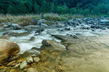 River water flowing through rocks at dawn