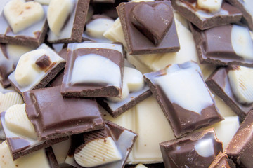 Pile of assorted chocolate bars close-up.