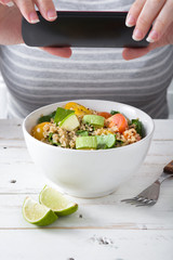 Woman taking a picture to food with a mobile phone
