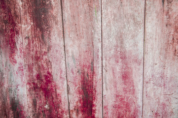 Aging pink and red wooden fence
