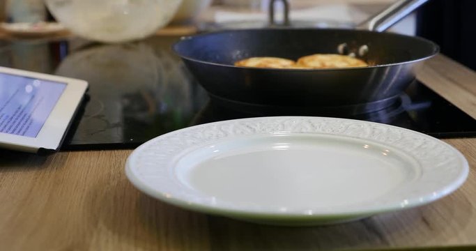 Woman opens the lid and the pan gets fried cheese dessert