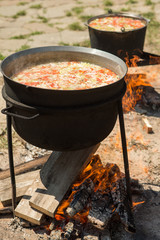 cooking on a fire. fish soup on a fire. pilaf on a fire. food in