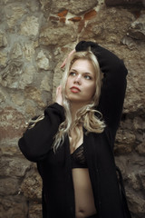 Fototapeta premium Pretty woman in unbuttoned shirt near the rocks