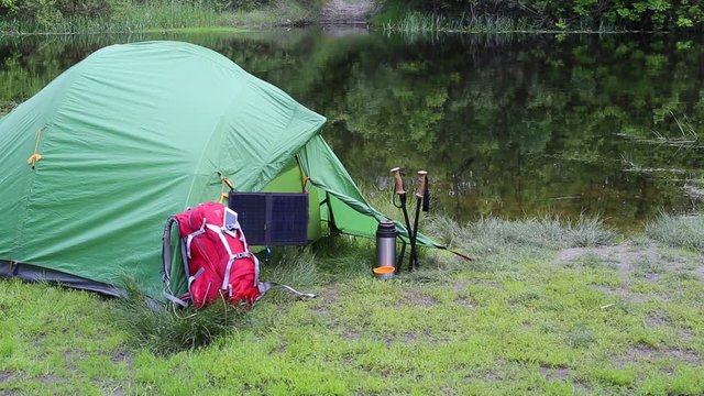 Camping in the woods on the banks of the river.
