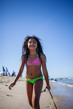 Girl strolling on beach with seaweed, Truro, Massachusetts, Cape Cod, USA