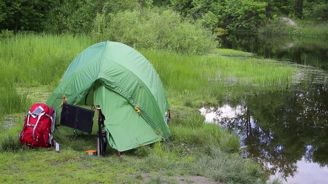 Camping in the woods on the banks of the river.