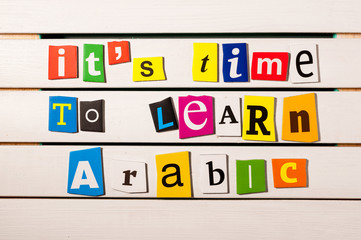 It's time to learn Arabic - written with color magazine letter clippings on wooden board. Learn...