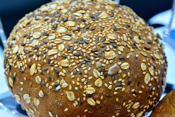 Loaf of black bread sprinkled with seeds