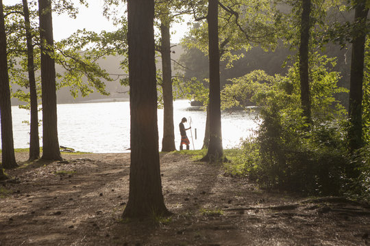 Teenage boy fishing at forest lake, Arkansas, USA