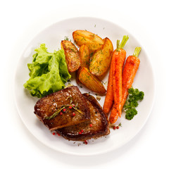 Grilled beef steaks and vegetables