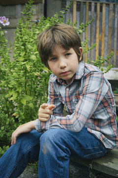 Portrait of boy pointing finger on allotment