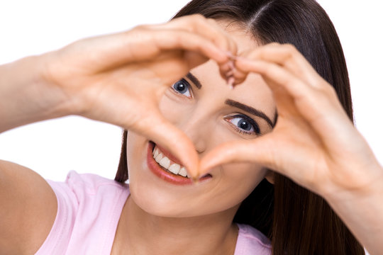 How Much Do You Love Me?? A Cropped Portrait Of A Beautiful Young Woman Making A Heart Shape With Her Hands