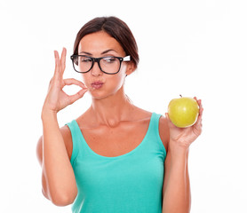 Congratulating brunette woman with an apple