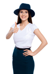Great job! Young woman in hat giving the camera a thumbs up.