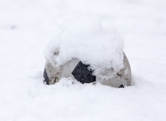 soccer ball in the snow in the winter