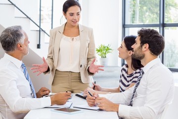 Businesswoman is talking to her colleagues who are listening car